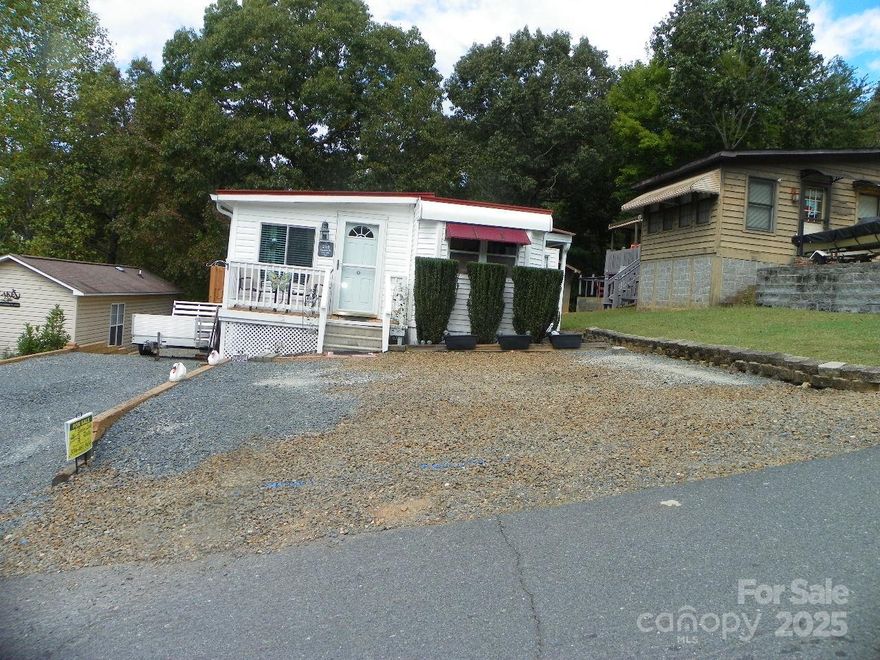 Visit this great RV community of Badin Shores Resort- Great for full time living AND just Steps away from JOEY'S Restaurant/Bar and Boat Launch!! The stick- built room addition gives extra room AND fabulous lake and mountain views from all new windows. For your convenience an updated step-in shower. Newer- low maintenance vinyl siding and metal roof, Spacious deck on the back for those restful and relaxing days! New retaining wall added 2025.  New Stove, water heater, and Microwave .  Central heat and Air, large laundry room. Small deck on the front.  Storage building (8x8) in the back remains. To remain:  BR furniture, blue storage facility,  laundry area- storage cabinet. GREAT PARKING! enough space for 5-6 vehicles!! 
ANJOY ALL the great amenities that Badin Shores Resort offers!!  Swimming pool and  separate Kiddie pool, sandy Beach, picnic area, basketball, horseshoes, Marina, boat launch, Chapel, Clubhouse that you may reserve and MORE!   Give us a call today!!   Price been reduced by $10,000!!! MAKE THIS GREAT FIND YOURS AND be ready for summer fun!!  MAKE NEW FRIENDS!! :-)