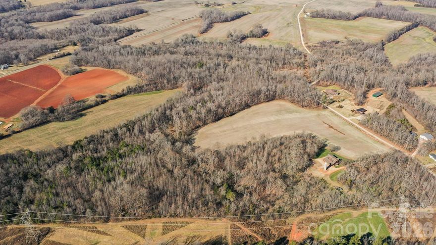 Welcome to Big Oak Tree Farm, a beautiful recreational property designed for the outdoorsman who loves the peace and quiet of the North Carolina countryside! This luxurious offering provides a back to nature escape with true rustic elegance and a lodge-like feel!
Land
The entire property is made up of two parcels and boasts 201.83 acres of prime recreational ground!  A mile long section of Sills Creek runs right through the heart of the property providing a great water source for the land and the wildlife.  There is a mix of hardwood ridges and draws, tillable farm ground which is leased to a local farmer, a power line right of way and a gas line right of way that have both been planted and kept up by the current owner!   Several food sources and cover grasses have been planted to benefit the wildlife in the area and improve the hunting opportunities!

The name “Big Oak Tree Farm” comes from the enormous and historic oak tree located near the home.  It is considered by a local arborist to quite possibly be the largest oak tree in Rowan county!   According to the arborist, the tree is estimated to be between 225 and 250 years of age!  The owner has went to great lengths to protect this giant of a tree by running a lightning rod from the tip of the tree down its major arteries and branches and into the ground to keep it from being destroyed by a lightning storm.

There are two easements across the property.  One is a power line easement and the other is a gas line easement.  Both provide great areas for multiple food plots and tillable ground for crops.
This land has been cultivated by the owner into a prime hunting and recreational property!  With a good mix of timber and open spaces, there are plenty of dialed-in food plots and fields planted in corn and soybeans equipped with Redneck hunting blinds and Family Traditions ladder tree stands!

With a side by side or ATV you can use one of the many trails to reach any section of the property to hunt!  There are even some great hunting blinds within a minute’s walk from the house!

Several good whitetail bucks and long beard turkeys have been harvested on the farm along with other small game animals!

Sills Creek runs through the property and provides a great water source and cover for wildlife with the thickets and timber along it’s banks.

Located in the heart of the property is a timbered creek bottom that has some great duck hunting potential!

This offering also provides plenty of groomed trails for horseback riding!

All total, there are approximately 45+/- acres of food plots and planted tillable acreage that have been consistently planted and maintained by the current owner and a local farmer.  A mix of summer and fall food plot blends along with corn and soybeans have been the main source of food for wildlife on the property.

There is plenty of agriculture surrounding this farm, however after the harvest season, this place has the only good food sources around and it attracts a lot of wildlife from the area!