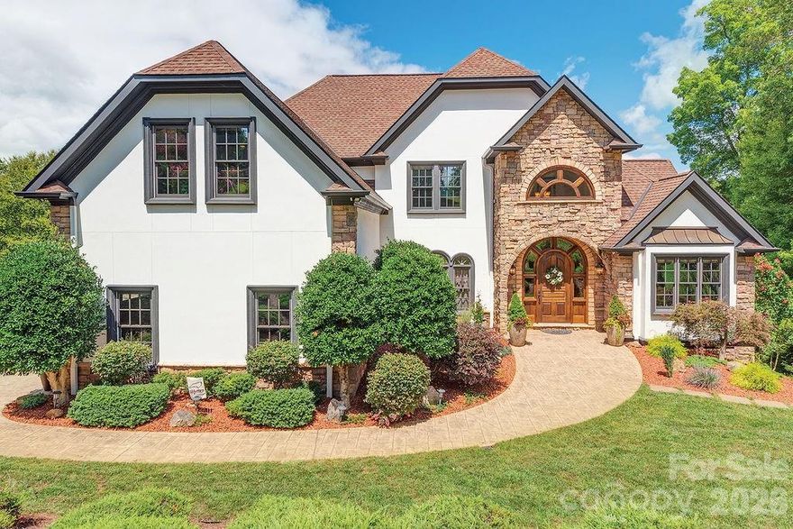 Experience exceptional mountain living in the gated community of Waterford Lakes, nestled in the breathtaking Cane Creek Valley. From the moment you enter, you’re surrounded by pristine landscaping and sweeping mountain views that set the tone for this remarkable three-story Developer choice custom-built home, rich with detail and craftsmanship throughout.  This stunning residence offers 5 bedrooms, 6 bathrooms, designed for both elegant entertaining and everyday comfort. Interior features include hardwood floors, solid wood crown molding and chair rail, granite countertops throughout, and multiple inviting living spaces. The custom chef’s kitchen showcases porcelain flooring, a gas-vented stove, cast iron sink with brass faucet, double ovens, a large center island, gas fireplace, and an adjoining keeping room—perfect for gathering. A formal dining room adds a touch of classic sophistication.  The primary suite is a true retreat, featuring a spa-like bathroom with full-body shower system, garden tub, walk-in closet, custom cabinetry with a built-in refrigerator. The lower level includes a second primary suite and a spacious entertainment area complete with a full bar/kitchen, solid wood cabinetry, built-in microwave, and beverage refrigerator.  Enjoy an entrainment room, sauna, large game room area. Step outside a large, partially covered deck with hot tub, ideal for relaxing while taking in unforgettable sunset mountain views. Additional amenities include a sauna, expansive entertaining spaces, and thoughtful details at every turn.  The community incudes a stable for those who want the horse experience. Location is key and within 20 minutes to DT Asheville and Hendersonville. Close to the Blue Ridge Parkway, great hiking for the adventure lover.