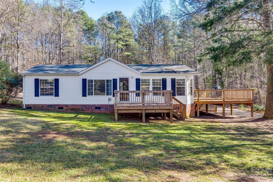 Come see this great home in Shiloh Quarters. This 3BR/2BA residence features an open floor plan with lots of living space.  The kitchen/dining area also includes an island with a breakfast bar and storage.  Family room has a remote ceiling fan and a propane gas log fireplace for cozy evenings. Primary bedroom features a remote ceiling fan, walk-in closet, and ensuite bathroom with garden tub and separate shower. Laundry room is conveniently located off the kitchen with additional cabinets. Updated vinyl plank flooring throughout the home.  Private, wooded 1.29 acre lot is located on a cul-de-sac.  The home features a front deck and an overside side deck for outdoor entertaining. Back yard is completely fenced in. There is a stick built 24 x 24 vinyl detached garage on concrete foundation with power and water.  Come make this country setting home!