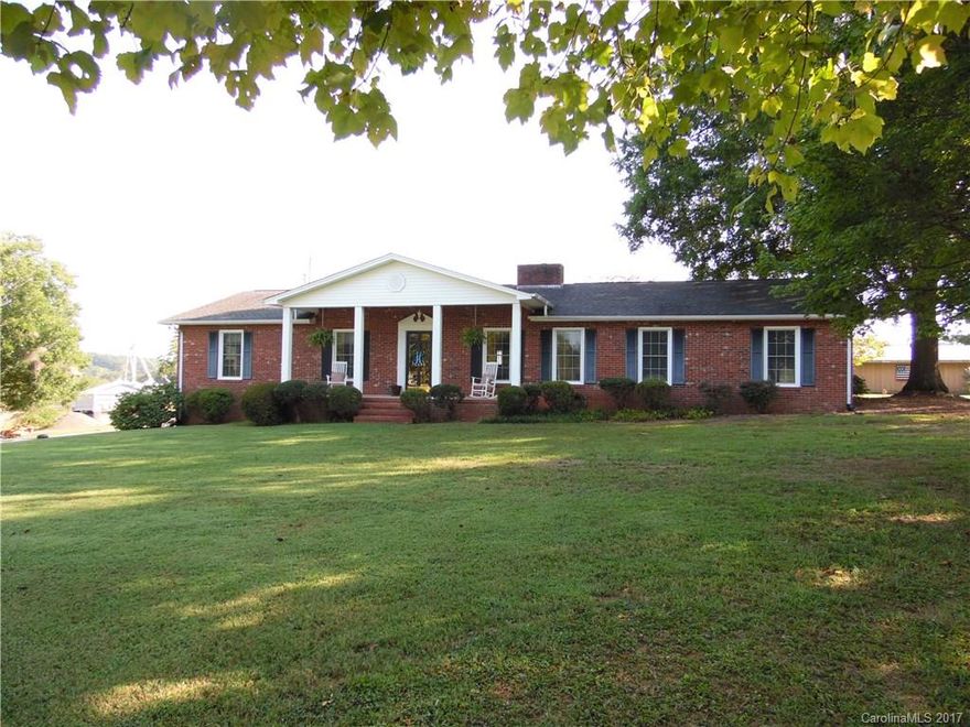 Comfortable Country living on the border of Stanly County. Over 1,800 htd. sq. ft., 3 BD, 2 BAS. Open kitchen & dining, office, 2 car garage. Updated Elec. & plumb. Approx 1,000 htd sq. ft. in basement. Storage/Barn buildings w/views of rolling fields.