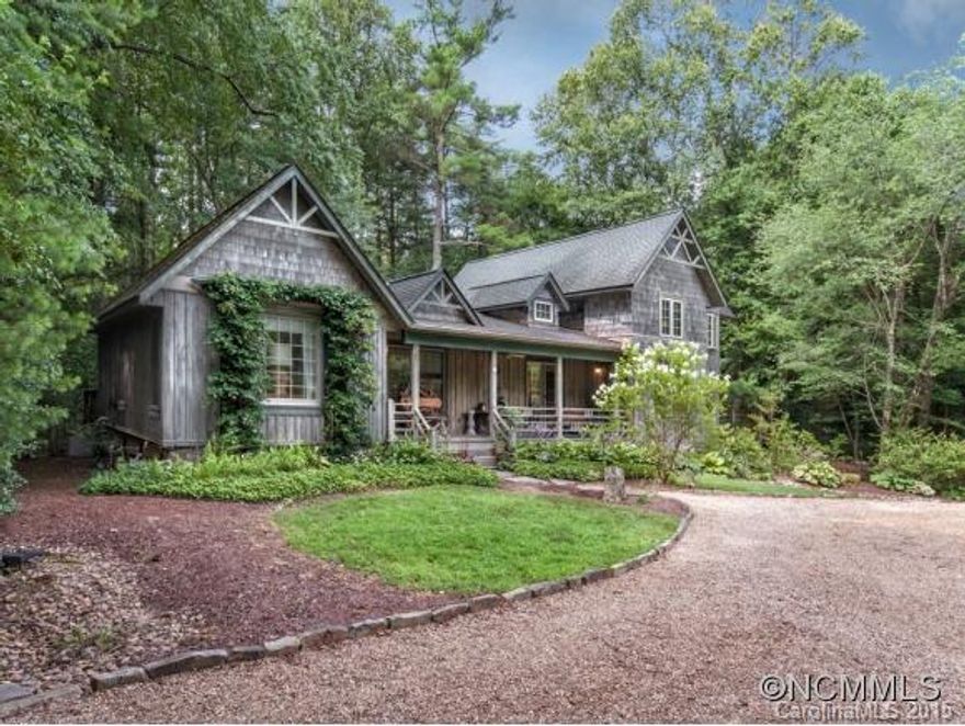 An historic cabin lies at the heart of this Robert Griffin designed mountain cottage. Centrally located, yet private and secluded. There's more than meets the eye, including an upstairs guest suite of 2 bedrooms with it's own separate entrance, 878 square feet not included in the total square footage. Beautifully landscaped with water feature. Triple car garage.