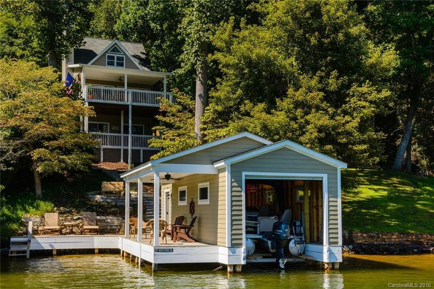 LAKEFRONT Cottage on LAKE LURE Main Channel.  NEW BOATHOUSE 2014. Picket fence welcomes you to this Immaculate Lakefront Cottage. Tasteful Décor.  Light  Interior opens to two Lakeside Covered Decks. FLOOR TO CEILING WOOD BURNING STONE FIREPLACE.  Cathedral ceiling.  Brazilian Cherry Hardwoods.  Easy steps to Private Dock.  2nd level private master suite.  Living room and guest rooms open to lakefront covered decks.  Parking for 3-4 cars.  Low maintenance landscaping. Furniture negotiable.