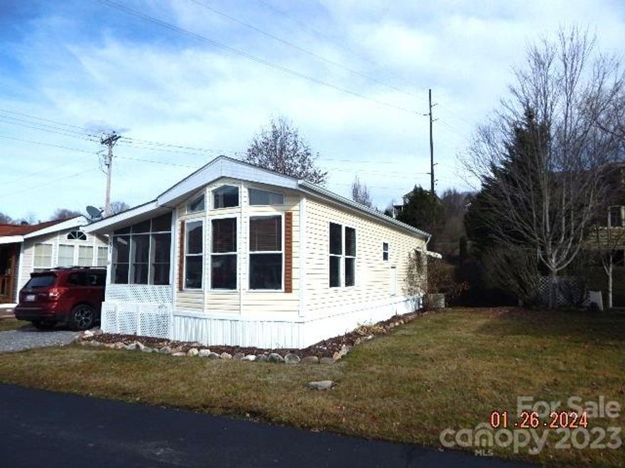 Hard to find furnished Park Model in the sought after community of The Summer Place. Easy paved year round access, beautifully maintained subdivision roads, and low annual HOA fees ( $100/yr ) only 3 miles from I-40 Exit 20. This well maintained home offers a full bedroom with large closet, semi remodeled bathroom, living/dining area with updated laminate flooring plus a large screened, covered deck which could be enclosed,  and an additional adjoining porch which has recently been repainted with non skid paint.The kitchen has been remodeled and offers lovely granite counters and Samsung range. There is a private area out back with a babbling brook for your enjoyment. The storage building houses the washer and dryer plus it has a lot of other storage space for all your gardening needs. Don't miss this opportunity, to own an affordable, low maintenance summer or year round home close to Maggie Valley and minutes away from everything Waynesville has to offer.