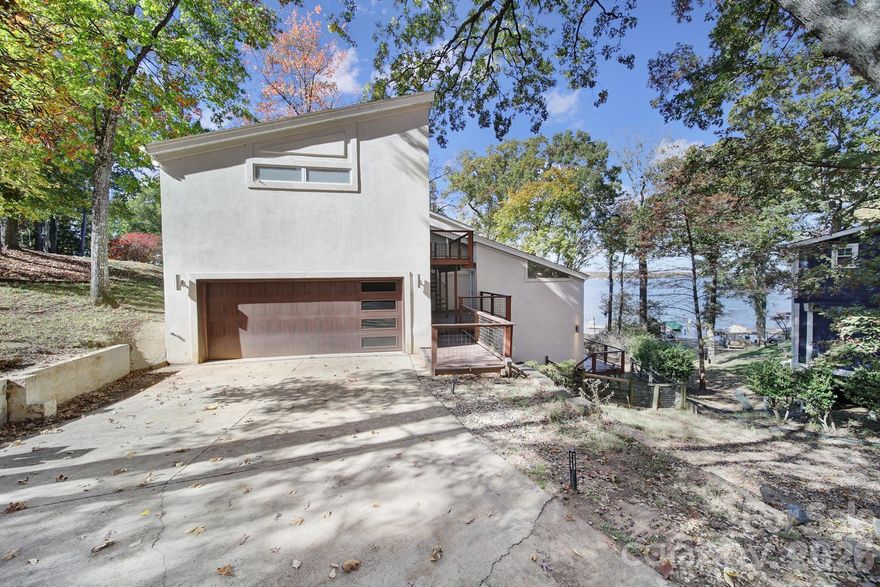 Welcome to this Rare Piece of Lake Wylie History! Discover endless possibilities with this spacious home situated on a half acre double lot right on the shores of Lake Wylie, complete with its own dock and stunning big water, main channel views. Originally owned by prominent Civil Rights Attorney Julius Chambers and then updated by renowned Architect and Mayor of Charlotte Harvey Gantt. Home also has an oversized 2 car garage with additional assigned parking spots in the culdesac. Brimming with character and charm, this property offers a unique opportunity to update and personalize a true classic as it was one of Tega Cay's first "model homes" — creating your dream lakeside retreat. Enjoy the serenity of waterfront living with the convenience of being in a top-rated school district and close to shopping, dining, and all that the area has to offer including the neighboring marina and nearby golf course and sport courts. Homes like this don't come available all that often so embrace the chance to own a piece of Lake Wylie history and make it your own! Kitchen and bathrooms have all been updated with custom built ins at the primary closet. Dual primary suites on opposite ends of the house. No HOA! House is currently listed well below our recent appraisal as seller is motivated and not looking to do any repairs as they no longer live in the area and haven't lived in the home for a few years now.