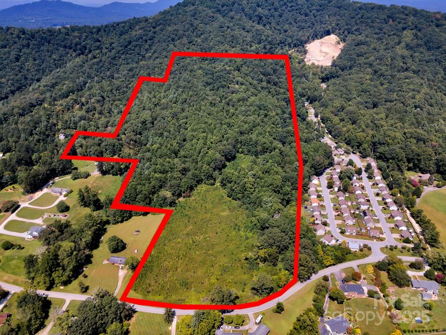 Highly sought after tract of land in popular Hoopers Creek area with over 470 feet of road frontage on Hoopers Creek Road! Multiple use options here including residential development, private estate, etc. Multiple building sites, long range mountain views, and a location that gives you privacy AND proximity to everything that you love about the mountains of Western NC. 5 minutes to Hendersonville Rd, 10 minutes to I-26, 15 minutes to I-40, 15 minutes to downtown Hendersonville and the Blue Ridge Parkway, 20 minutes to Biltmore Village/Biltmore Estate, 25 minutes to downtown Asheville. With the road frontage on Hoopers Creek Rd and easy access to stores/shopping/fun it's easy to see why this is NOT your typical mountain tract of land. This is a blank canvas with perks. Come and see for yourself!