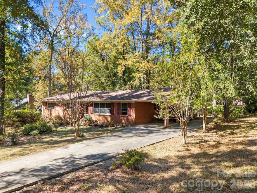 Nestled at the end of a private, tree-lined cul-de-sac, this full brick 3-bedroom, 2-bath home sits on a peaceful one-acre lot in the heart of Rock Hill. Features include a carport, quick access to downtown shops, dining, and entertainment, and a $3,000 flooring credit for the laundry room and second living space. Privacy, convenience, and opportunity—worth a tour.