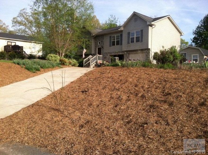 Dreaming of a home in a great neighborhood with lush greenery of the landscaped trees and shrubs greeting you as you arrive onto the property? Springfield may be the place for you. As you enter, notice the open space and the cathedral ceilings that flow from the Living Room, Dining Room, and into the Kitchen. As you journey down the hall into the bedrooms, observe the spacious area of the rooms and closets. The Master Suite displays a Master Bath with tub/shower combo and closet/cabinet space. Take a tour of the finished Basement, with a spacious Den area with  bath, gas fireplace, L-shaped counter with cabinets/wet bar sink, and a place to curl up for some quiet time. Enjoy the secluded feel of the back yard with views across the field from the covered deck. This home is conveniently located within minutes of Lenoir, Valdese, and Morganton, in addition to local shopping, medical facilities, golf courses, walking parks, and schools.