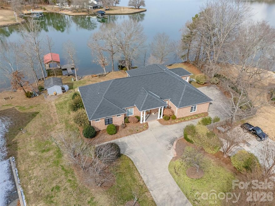 Waterfront living on Lake Wylie with NO HOA, located in the highly regarded Clover School District and just minutes from the Charlotte Airport, restaurants, offices, and everyday conveniences. This solid brick, one-story ranch home offers true lake living with two docks, a boat lift, and endless opportunities to boat, ski, and fish right from your backyard. Thoughtfully designed for comfort and flexibility, the home includes a separate office or art studio with its own entrance and dedicated heating and air system, ideal for working from home, hobbies, or guests. Inside, you’ll find a grand primary suite, along with a handicap-accessible bedroom suite on the opposite side of the home, making this a one of a kind place suitable for multi-generational living or aging in place. There's a gas line available for future grill a Rinnai tankless hot water system, and features a newer roof and HVAC, offering peace of mind and efficiency. Unwind on the screened porch and take in peaceful water views, or step outside and enjoy the lake lifestyle so many dream of but few find. A rare combination of lakefront, location, accessibility, and flexibility, this is Lake Wylie living at its best.