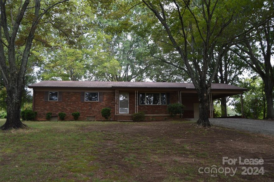 Lovely brick ranch style home located in west Statesville. Mature hardwoods in the front yard. Practical floor plan with three bedrooms all on the main floor. Full bathroom in the hallway and a half bathroom in the primary bedroom. Basement is unfinished and does have ample room for storage. There is an interior and exterior entrance to the basement area.