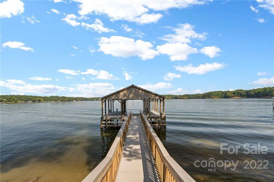 Magnificent sunset water views from almost everywhere in this home on a main-channel point lot in prestigious Northview Harbour. All brick custom home with oversized 3 car garage on a private cul-de-sac lot with plenty of space to entertain. Chef’s kitchen features custom cabinetry, island, new appliances and range hood with adjoining breakfast area overlooking the lake. Main level primary suite with luxury bath, sitting area and dual closets. Two additional bedrooms with jack/jill bathroom on the main level. Upstairs you will find a large bonus room and plenty of additional space to use for guests, private office or flex space. Expansive lower level offers 8 seat theater room with 10’ screen, 2 full baths, 2nd primary bedroom, rec room and walk in storage area with utility doors to easily store lake toys. Outdoor space features main level composite deck, lake level patio, private sandy beach and pathway leading to covered stationary dock.