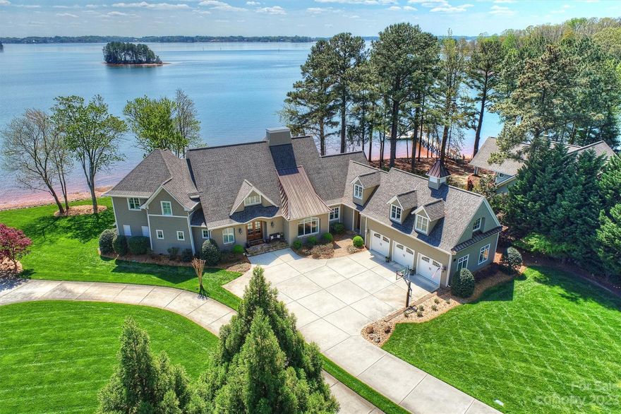 PRIME LOCATION down Brawley! Wide open views & private pier w/boat lift. Beautifully designed with lake views in mind, warm & inviting, yet casually elegant. Open layout, chef's kitchen, Thermadore & Bosch appls, 2 offices and a beautifully laid out owners suite, bathroom, walk in closet & a laundry room. Upper level has 3 bdrms & baths, 2nd laundry, sitting area, bonus room, an exercise rm & a huge rec room. There is built in storage throughout the house & outdoor storage for water toys. Room for a 2nd stairway if wanted. No HOA. A mile past The Point. Hauge water purification & filtration system throughout the house.