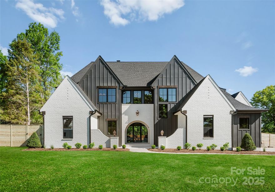 Welcome to this exquisitely crafted Modern Tudor, perfectly situated in the heart of Cornelius w/ lake access. Step through the grand arched doorway into an open living space w/ soaring ceilings, hardwoods throughout, & a chef-inspired kitchen that inspires. The kitchen features a massive island, solid wood shaker-style cabinetry w/ soft-close, under-cabinet lighting, quartzite countertops, stylish tile backsplash, a 48" premium gas range, & scullery w/ abundant storage. An expansive primary suite offers a custom-designed walk-in closet & private laundry room for added convenience. Both the primary & second-floor en suites showcase frameless glass, zero-entry showers. Additional laundry room upstairs, w/ a sleek fluted glass door. Step outside to your private lanai, complete w/ a 42" gas fireplace— next to the sparkling saltwater pool and spa. The home is pre-wired for seamless A/V & internet connectivity. Don’t miss the chance to own a brand-new, luxury home in the heart of Cornelius!