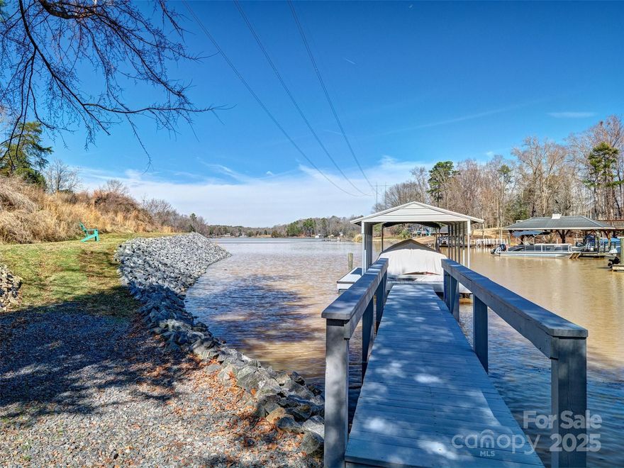 Unique waterfront lot with DOCK IN PLACE including electricity and water at the dock! The owner has an approved engineered septic system plan from the county and building site staked out with county approval.  Lot is 3.15 acres and is flagged all the way around.  Small portion is across the road and that is where the county approved 1 area for the septic for 4/5 bedroom home and bore under the road.  There is also a spot for engineered septic on the front of lot toward lake. Seller has already paid for the plans and permits.   Bring your builder or use mine.  The sellers have this lot combined with their home at 820 Cooks Cove Road now, with current survey, and in the process of separating it for sale.  Please call me with any questions and I am happy to walk the lot and explain the logistics.