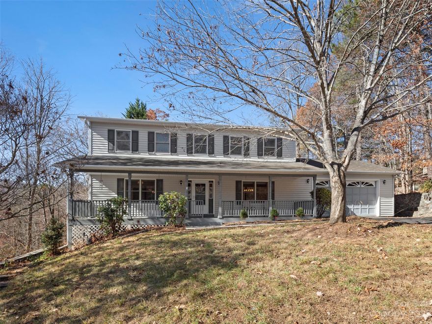 Nestled within the charming town of Fairview, North Carolina just 12 min to downtown Asheville, this 4-bedroom, 3.5- bathroom traditional home offers just over 3100 sq. ft. of comfort. Located in the secure gated community of Fairview Downs, this residence offers a perfect blend of privacy and community living, creating an idyllic retreat for those seeking a tranquil yet connected lifestyle. This home offers a peaceful covered front porch and a private back deck. With two separate driveways and two separate two car garages, one on the main level and one on the basement level, there is plenty of room for parking or for that workshop that you have always wanted. The fenced back yard is the perfect spot to play or entertain. If you are looking for a large home with tons of storage and potential, this is your home!