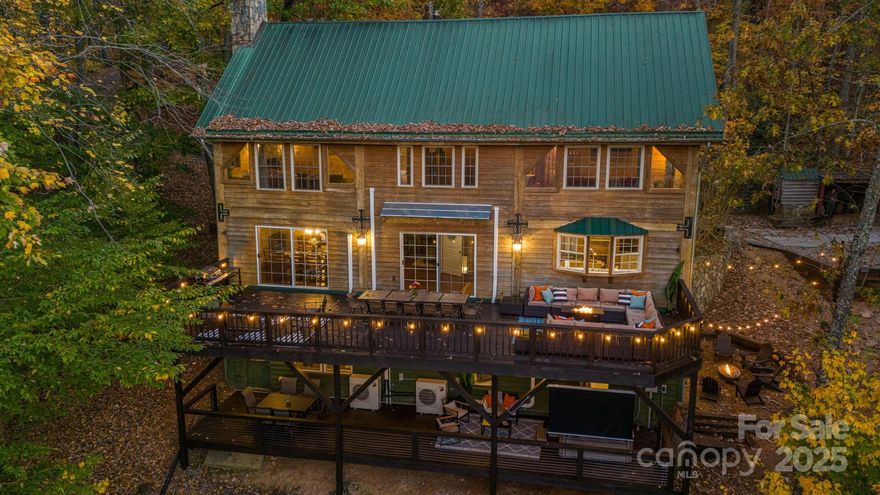 Incredible opportunity to own a successful short-term rental just 20 minutes from Asheville. This stunning 5BR/4BA with one bonus room mountain lodge retreat sits on 3.14 private wooded acres and sleeps up to 15. Blending rustic charm with modern comforts, it features a fully equipped kitchen with stainless appliances, stone fireplaces, and a spacious game room with pool table, skee-ball, board games, and smart TV. Multiple porches offer breathtaking mountain views, including one with an outdoor movie theater. Relax in the hot tub nestled among the trees or gather around the stone fire pit under the stars. Ideal for groups or families, with king, queen, bunk, trundle, and sleeper sofa options. Fast Wi-Fi, in-unit laundry, and parking for 4–5 vehicles. Minutes from hiking, attractions, and Asheville. Launched in mid-Nov of last year, this short-term rental already has $106,588.28 on the books, with an almost $15K October coming up. Turn-key opportunity for investors or second-home buyers. One or more photo(s) was virtually staged or rendered to show use concept.