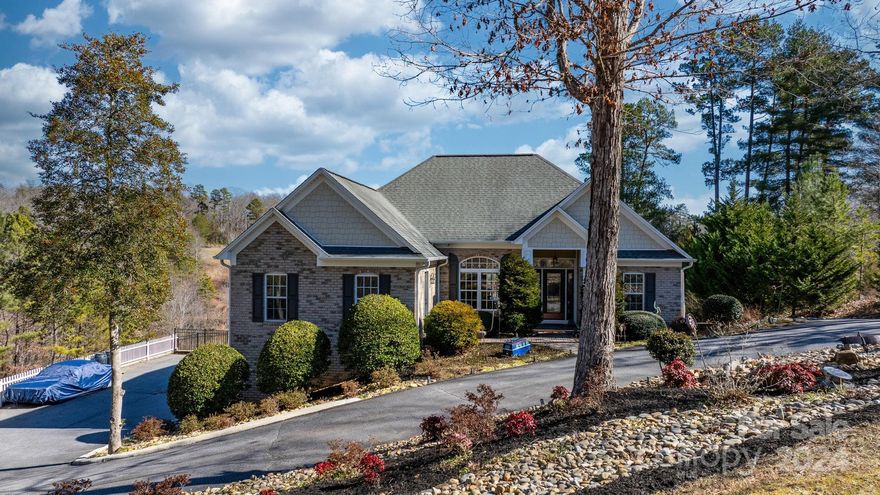 Welcome to your dream lake home retreat! Nestled on 3 lots w/ a dock. Step inside to discover a thoughtfully designed main level showcasing 3 bedrooms, 2 full baths, & a separate living room/den area for ultimate comfort & convenience. The gourmet kitchen is a chef's delight, adorned w/ granite countertops, SS appliances, & a gas range, while the living room invites relaxation w/ a cozy gas FP & tile that extends seamlessly to the ceiling. HW flooring & tile throughout add elegance & durability to every corner. Descend to the basement where you'll find a 2nd kit, living room, & full bath, perfect for entertaining or accommodating guests. The basement garage offers ample space for parking & storage. Outside, indulge in resort-style amenities including an above-ground pool, inviting pavers, a hot tub, & covered deck, providing the perfect backdrop for unforgettable gatherings and tranquil moments by the water's edge. Don't miss this opportunity to experience lake living at its finest.