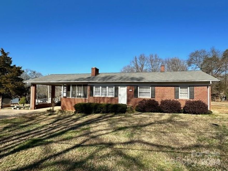 PRICE IMPROVEMENT!!! UPDATED PICTURES!!! Very nice, brick home that is close to Main Street Forest City and the Thermal Belt Rail-Trail. This 3 Bedroom/2 Bath home also has an attached screened in porch that is over 200 sq ft and would be perfect for outdoor living or an entertainment area. The 20x40 building/work shop is connected to the driveway and has a garage door. Large primary bedroom with it's own entrance to the spacious back deck and attached primary bathroom.  Hall bath has a walk-in shower that is only 2 years old. Living room also has lovely, brick fireplace with gas logs. Home has natural gas, city sewer and city water. The home will be sold AS IS. Refrigerator, Oven, Washer and Dryer will all convey with the sale of the home.