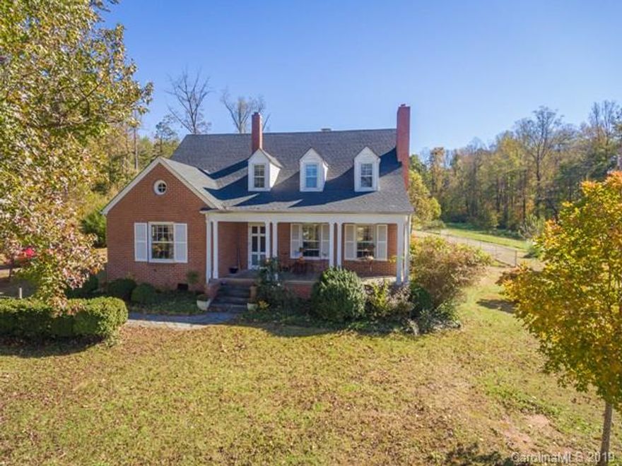 Charming 1940's brick Cape Cod farmhouse on private 17 acres of pasture and wooded property. Welcoming covered slate front porch.  Beautiful restored hardwoods throughout main and upper levels.  Living room has wood stove and built in bookshelves.  French doors lead to a formal dining room and spacious kitchen.  Laundry is located off kitchen on sunporch.  Two bedrooms on main level with hall bath.  Upper level features two large, dormered bedrooms with another full bath. Original stone well house, small utility building and carport.  Brand new firepit and pergola over rear patio.  Fenced rear yard for pets and raised beds for gardening.  Partial basement with complete waterproofing and new sump pump.