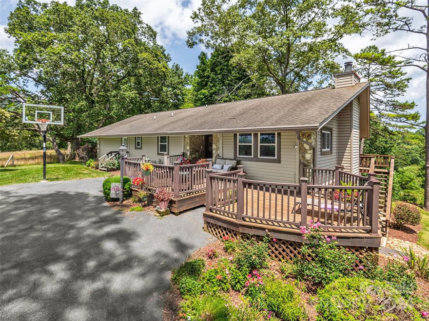 Nestled conveniently between Waynesville and Asheville, this stunning home offers year round mtn views &
modern conveniences, including high-speed internet. Centrally located to the hospital, Haywood Community
College, and I-40, this property provides easy access to essential amenities and transportation. 5 BR/4BA,
this spacious residence features a spacious living room with a vaulted ceiling & a wood-burning stone
fireplace. Updated kitchen is a cook's dream, while the primary suite boasts a walk-in closet and a large
ceramic tile walk-in shower. The main level includes a convenient laundry/mud room. The property also
features a split driveway with ample parking space. The daylight basement is ideal for multigenerational
living, offering a family room with gas logs, a wet bar, & a second set of laundry hookups. You'll find
plenty of storage throughout, & the new back deck provides a perfect spot to enjoy the serene
surroundings.