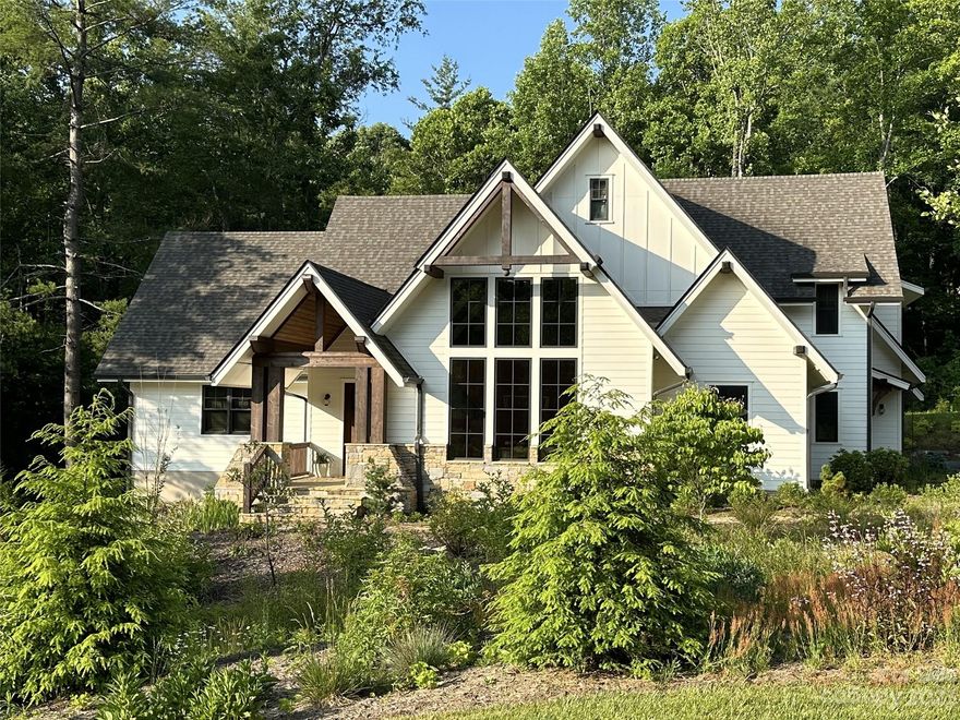 This impeccable custom-crafted modern farm house is situated among meadows of wildflowers and native species plants. You’ll be lured in by this home that was built and first occupied in 2020,with only one owner in the beautiful gated community of Poplar Ridge. The inviting foyer greets you with a warm and calming embrace, opening up to the light-infused living room that flows effortlessly to the dining area and gourmet kitchen. Vaulted ceilings, wood beams, stone facade gas fireplace, floor-to-ceiling windows, intricate crown molding, and a natural color palette enhance every one of your senses. The main level primary suite is a place to retreat after a long day with a well-appointed bathroom and large walk-in closet. Upstairs you will find two ensuite bedrooms, plus a bonus room, currently utilized as a home gym. Outside, the ingeniously crafted deck will exceed your entertaining expectations with ample privacy & space to enjoy the seasons.