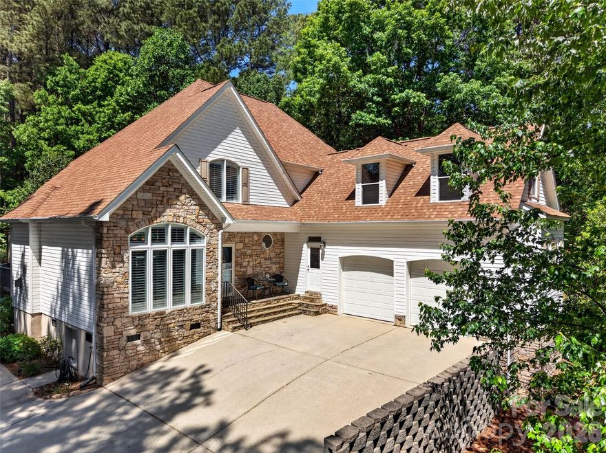 Welcome to this one-owner home on Granite Street in the small community of Somerset Lake Norman!! This custom home is situated on a private, wooded lot with seasonal views of Lake Norman in Terrell, NC. A well-manicured lawn and exterior envelope you as you drive up to the quiet, peaceful setting. This transitional home features a 2-story Great Room w/gas logs fireplace and gleaming hardwood floors with an open living area, formal Dining Room & a cozy Breakfast room with bar. New windows in 2026 feature Plantation Shutters and custom roller shades that overlook the spacious Deck with pergola and private backyard setting. The Kitchen features hickory wood cabinets, electric cooktop w/microwave hood, wall oven, a new stainless steel dishwasher, disposal and a large pantry. The spacious Primary Bedroom is on the main level and has a cozy gas logs fireplace and large en suite bathroom with huge walk-in closet and laundry chute! The Primary Bathroom has dual vanities, a garden tub and separate shower. Powder Room on main level for guests is tucked away in the back hall. You will love the Large Utility room with Laundry hook-ups, built in cabinets and utility sink which is right off the Garage and side utility door. The upstairs has 2 good-sized secondary Bedrooms, large closets and a shared bathroom with double vanity areas. There is a nice Bonus Room over the garage with additional flex space, which was originally designed as a home theater w/ wet bar and home gym. Convenient attached, 500-sq ft double garage with built-in shelving for additional storage. Irrigation system and recent spring yard service; encapsulated crawl space. Nestled halfway between Mooresville and Denver for schools, restaurants, shops & conveniences in either direction!! Just 5 minutes to Midway Marina with Boat Rentals and private Boat Clubs, and only 7 minutes to both Pinnacle and McCrary Creek Public Lake Access launch sites!! Come live the Lake Life!!
