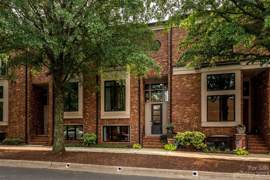 Discover urban living at its finest in this stunning brownstone located in the vibrant NODA neighborhood. With an array of shops, restaurants, and music venues just steps away, this home offers the perfect blend of convenience and culture. Main level is an entertainer's dream, an open concept flowing from dining, kitchen, family room. Fabulous kitchen showcases a large quartz island, Bosch appliances, upgraded cabinets, and opens to huge 15x19 family room w/brick accent wall plus wall of windows to the patio. Upstairs find two primary suites w/luxury spa baths & custom closets, and a versatile first-floor guest suite/home office w/private bath. One primary boasts views of uptown! Two-car rear garage+street parking. Custom lighting, ample shelving/storage throughout, gorgeous stair runner, cable stair railing, custom shades/treatments on every window complete this extraordinary home. Experience contemporary elegance in this exquisite NODA townhome.  Close to the Lynx train line!