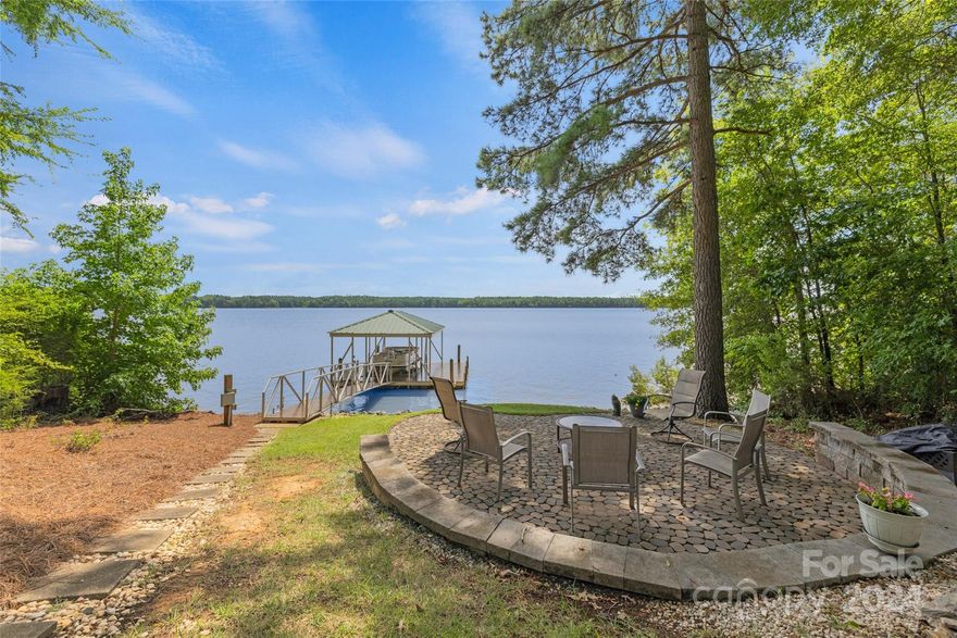 Are you longing for a lakefront home with your own dock? Look no further, this is the one for you! Gorgeous lakefront views, fishing, boating, countless memories & more await you just a short distance from Charlotte or Columbia. Discover your dream home in this stunning, meticulously maintained waterfront ranch w/ walkout basement perfectly nestled along serene shores. The sun-drenched living area boasts a spacious open-concept, large windows framing the captivating water vistas from almost every room, stone fireplace, plenty of entertaining space & French doors for indoor/outdoor living & entertaining. Additionally, the luxurious primary suite, generous guest rooms & baths provide ample space & privacy. More entertaining & fun await in the finished basement w/ gas fireplace, flex room & a spacious 3 season room. Outside, the sprawling deck & landscaped yard offer the perfect setting for outdoor gatherings, while the private dock invites you to embark on endless water adventures.