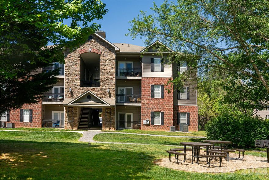 Discover maintenance-free living in this top-floor 2-bedroom, 2-bathroom condo located in the sought-after Grove at Appledoorn community. Offering a light and bright open floor plan featuring 9' ceilings that seamlessly blends the kitchen with the living and dining areas. Step outside onto your private, covered balcony to enjoy exceptional mountain views. Situated in a prime location, this home is just minutes away from the historic charm of Biltmore Village and the vibrant dining and entertainment scene of Downtown Asheville. This quiet 3rd-floor unit is one of the most well-located units in the community, providing a balcony overlooking the park with no neighbors above you. The interior includes a spacious primary bedroom suite with a private bath and walk-in closet, a second bedroom or office and  separate bathroom, a large laundry closet, and a private storage area. Gently lived in as a second residence, this home has been well-maintained and is move-in ready. The Grove at Appledoorn is a walkable, pet-friendly community featuring picnic tables and grills in the green space where neighbors often gather. Monthly HOA fees include city water and sewer, trash and recycling, and exterior and grounds maintenance. Please note that only owner-occupied units are permitted in this community; no rentals are allowed.
