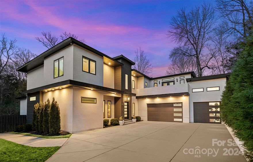 Welcome to this high-end modern design custom home, located in Paloma Springs that is nestled in South Charlotte. Situated in a prime location just a few streets over from the Arboretum shopping center, between the Ballantyne & South Park areas. This open concept design offers everyday functionality & features a welcoming entry with floating staircase; office; family room with gas log fireplace; spacious kitchen/dining area. Custom 4-panel sliding glass door opens to back deck. Kitchen with waterfall island, 42" cabinets, quartz countertops, & stainless steel appliances. Owner's suite on main with  spacious walk-in closet. Luxurious bath with dual floating vanities & huge tiled walk-in shower with freestanding soaking  tub inside. Upper level with 4 bedrooms, loft area, & bed/bonus room with balcony. Hardwoods on main & upstairs  hallways, bonus, & loft. Laundry chute. Irrigation, deck with gas fireplace & storage room. 3-car garage and fully fenced private backyard. Do not miss this!