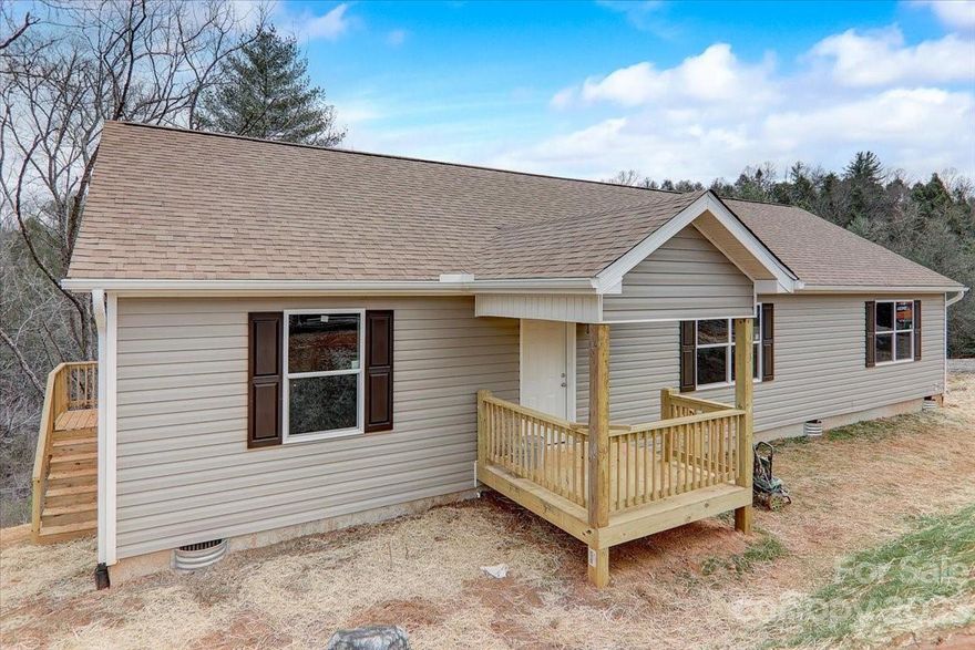 New Price, New Construction! 3rd house available at Rolling Hills of French Broad Phase 3. New construction right off Jenkins Valley Road. High Speed Internet with Spectrum. Close to schools and shopping stores very convenient to Asheville. One level living with split-bedroom floor plan, 3 bedrooms, 2 full baths, large master bedroom, kitchen with pantry. Main road will be paved once Phase 3 is completed. Only 15 min drive to the town of Woodfin, 7 miles to Patton Avenue and 15 minute drive to downtown Asheville. Subject to Woodfin taxes which includes free trash pick up. Listing Agent is the owner and builder.