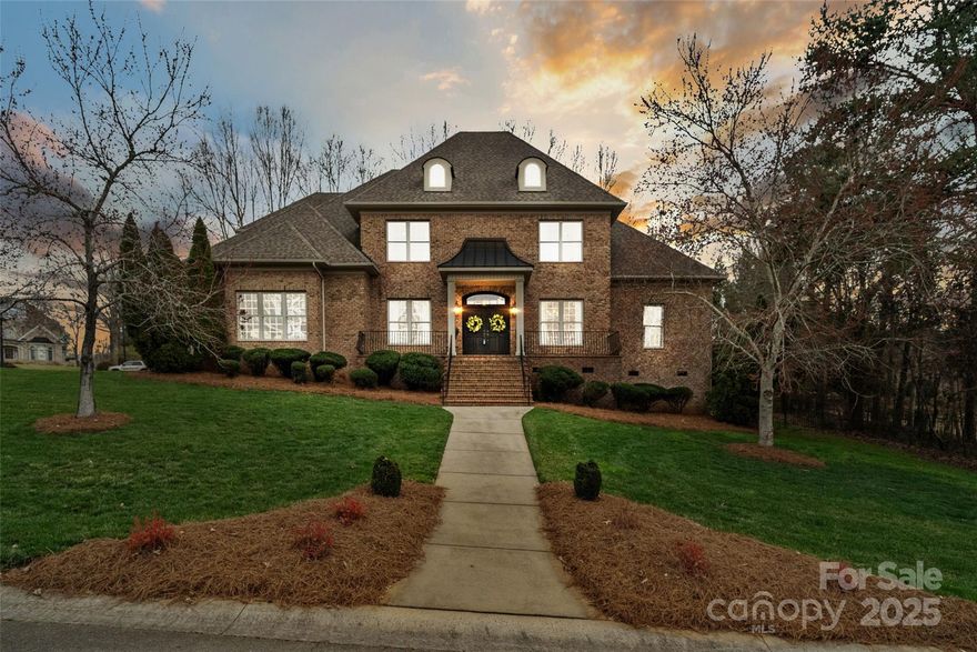 This custom-built house is a delightful blend of modern and traditional design elements which gives it a unique and stylist aesthetic. Located in one of Rock Hill's most prestigious neighborhoods, this 4600 square feet estate offers ample living space on the main floor for living and entertaining. When you walk through the double front doors, you will notice the pristine hardwood floors, exquisite moulding, custom built-ins, and dark painted doors throughout.  While the primary suite is conveniently located on the main floor, there are 4 additional guest rooms (each with a private bath) and a bonus room upstairs. The house offers enormous closets and walk-in attic space throughout -an organized homeowners dream. Step out the back door onto your private patio and grilling area or enjoy the lovely fire-pit on brisk evenings. During the summer enjoy a stroll by the beautiful lakes or the neighborhood pool and tennis courts.