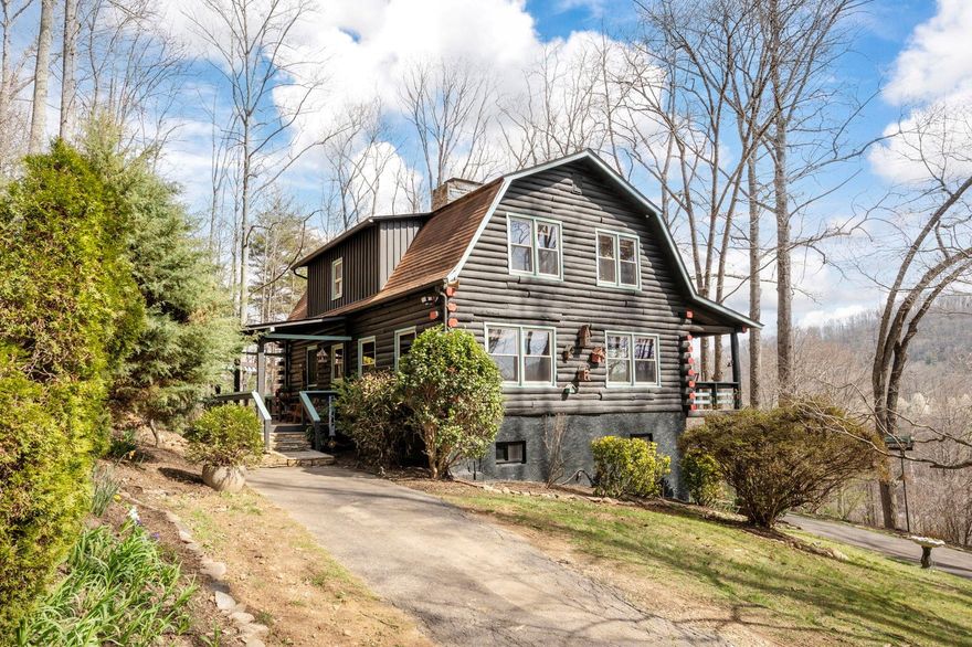 Quintessential log cabin (on almost 9 acres!) boasts year-round views and privacy. This beautiful property has great proximity to Lake Lure, Hickory Nut Gap Farm, a multitude of hiking trails — and endless peace and quiet, only 20 minutes to downtown Asheville. Outdoor living includes a covered, Southern-style deck, lower-level patio, and a second partially covered deck, all with beautiful views. Entertain from the 2019 remodeled kitchen, featuring granite and subway tile, and the warm living room with plenty of space for gathering. The primary bedroom, second bedroom (perfect for office), and full bathroom with jacuzzi tub are all upstairs. Inviting guest suite in the walk-out basement plus storage or workshop room with laundry. Property amenities include detached one-car garage, storage shed and waterfall feature. Ideal short-term rental (buyer to verify) or second home, no HOA or city taxes. Possibility of subdivision to be verified by buyer. See brochure and video for more detail.