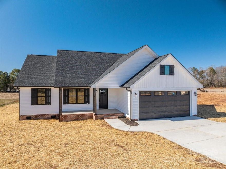 Stunning New Construction Ranch on Over an Acre!  Discover this 3-bedroom, 2-bath ranch in a beautiful Western Lincoln County setting within the Northbrook School District. Featuring an open floor plan, this home boasts vaulted and tray ceilings, luxury vinyl plank flooring, and a white kitchen with custom cabinetry, granite countertops, and stainless steel appliances.  The spacious primary suite includes a dual granite vanity, walk-in tile shower, and oversized walk-in closet. A split-bedroom design provides privacy for the large secondary bedrooms. Enjoy outdoor living with covered front and rear porches, plus a spacious patio. The two-car garage offers ample storage. Nestled in a fantastic neighborhood with top-rated schools, this home is move-in ready. Don’t miss your chance to own this perfect blend of modern luxury and peaceful living—schedule your showing today!