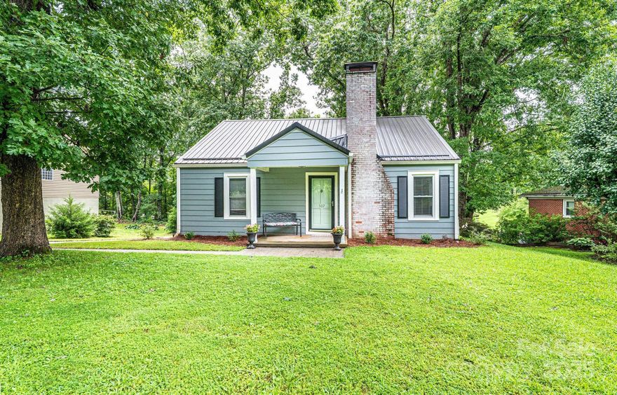 Charming bungalow awaits you with adorable curb appeal & fenced backyard, set on .29 acres, just in time for the holidays! A welcoming front porch & cheerful door lead into a warm, inviting LR with a cozy FP. Step around to the right into a bright dining area & kitchen with a handy bar. Down the hall, discover three freshly painted BRS & updated BA. The attic upstairs offers ideal flex space, complete with built-ins & closet space (403 sqft Non HLA because of ceiling height). In the basement, you’ll find laundry hookups, utility sink, & plenty of storage. A back deck opens to the lovely fenced yard and privacy. Single carport.  Beautiful, gleaming hardwood floors throughout the main floor add warmth, durable metal roof, & an efficient forced-air oil furnace with AC throughout. FP features a rain cap on the chimney for peace of mind.  Enjoy a fantastic in-town location—minutes from Morganton’s shops & restaurants, with quick access to Interstate 40 for Asheville, Hickory, or Charlotte. Home is in Drexel town limits with a Morganton address.