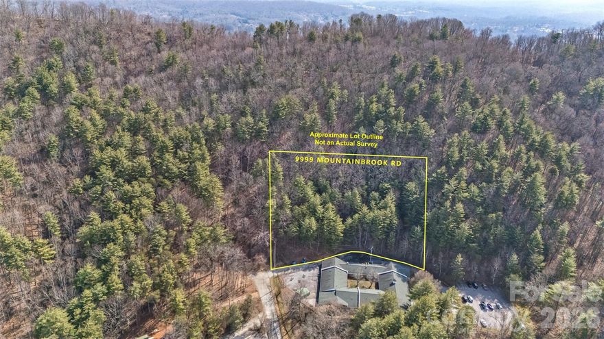 Wow, this beautiful lot in the Chunn's Cove area has all of the city conveniences, but none of the city taxes or restrictions!  Views from the likely build site will look across Chunn's Cove to Beaucatcher Mountain, mostly to the right of the Beaucatcher cut.  The lot is rich with trees and boulders.  It's less than 5 minutes to I-240, 6-8 minutes to downtown, & 10 minutes to I-40.  Enjoy the convenience of city living while tucked into the woods just outside city limits.  Drive city streets to your property, and forget city taxes & zoning regulations once you enter your driveway.  No worries about HOA fees or regulations either.  Lots of benefits with minimal baggage.  Beautiful sunsets await.