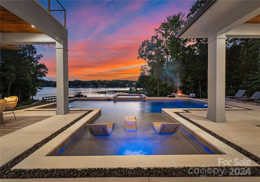 Welcome to this luxurious coastal modern retreat situated along the shores of Lake Wylie! Every detail of this custom home was masterfully planned with impeccable attention to detail. Ample natural light flows throughout with breathtaking views of the water from nearly every room. Whether entertaining or enjoying a relaxing evening, the open floor plan creates the ideal living space. Gourmet chefs kitchen extends into spacious great room that opens into stunning outdoor oasis boasting an outdoor kitchen & living area, saltwater pool & spa, private dock and sandy beach. Primary suite on main is complete with a fireplace, coffee bar, his & hers closets & elegant spa style ensuite. Upstairs features a loft, 3 ample sized bedrooms, flex space & bonus room that can be used as an additional bedroom. 3 laundry rooms for added lake life convenience as well as an indoor/outdoor bath. Low SC taxes and sought after Clover schools. Close to downtown Belmont, shopping, restaurants & the airport!