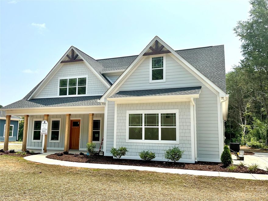 Don't miss your chance to get into this gorgeous new construction by custom home builder Tom Ras. The Thomas Farmhouse plan will feel like home with its welcoming covered front porch and solid wood craftsman front door. High ceilings, tall baseboards & wood flooring are just some of the details that will get your attention! Situated on over an 1+ acre lot, you have plenty of room to enjoy the setting. This open concept offers a primary suite on the main level with custom closet systems, trey ceiling and a beautiful spa like bath. You'll find 3 more bedrooms on the upper level. All of the bathrooms have quartz countertops, tile bath or shower and custom lighting. Your great room has a coffered ceiling and fireplace that can be enjoyed from the kitchen as well. The kitchen has a large center island, stainless steel appliances, quartz countertops, under cabinet lighting and recessed lighting. Enjoy the evenings from your covered patio. Just minutes from the University!