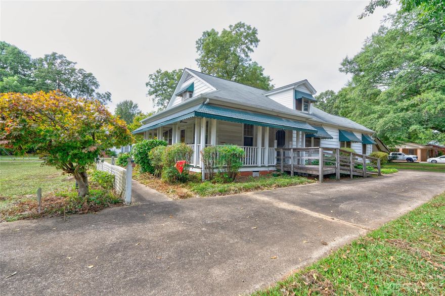 Welcome home to this 1940s 3 Bedroom 2 Bath ranch home on a corner lot in a prime location just inside the city limits of Shelby, NC! This home features over 2,000 square feet of heatable living space with an upstairs finished flex space! The convenient location makes this home just a short distance to all that Shelby has to offer! Upon entry to the drive, the wrap around porch, picturesque awning and lattice fencing are sure to catch your eye. This property boasts a circular drive with a pull-through carport accessible from both the main road and secondary road. The impressive character of this home has been delicately upheld and is awaiting its new owners to love and care for it, just as the generations before have done. In addition to the strengths of the home, you will find a wired workshop that is partially heated at the back of the property for storage or a hobby shop! With moderate TLC, this property could easily be revitalized to reestablish its original vintage charm!