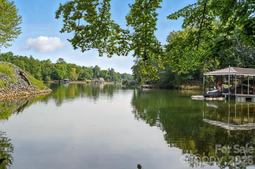 Your Lakefront Legacy Awaits! With its prime peninsula location, serene surroundings, & exceptional water access, this rare gem offers the perfect canvas for building the lakefront retreat you've always envisioned! Create lasting memories on this stunning 0.52-acre waterfront lot with a private dock off Windjammer Drive. Positioned on the highly sought-after peninsula of Tega Cay, the property is one of only a few remaining waterfront opportunities in this premier location. As you enter the lot from a quiet cul-de-sac, the property opens to reveal breathtaking long-range views of Torrence Creek, creating an ideal backdrop for your future home & private dock. Enjoy the best of lake-living on a calm cove, only steps away from Windjammer Park, offering quick access to the main channel. A natural walkway leads directly to the water's edge, where the permitted dock is ready for restoration. Soil work completed & silt fencing are already in place on the lot, streamlining your construction process. All large trees have been cleared from the potential build footprint, and more can be cleared on the perimeter to expand views. Nestled beside two beautifully crafted homes, this lot provides a clear vision of the architectural quality & style that defines this community where amenities include parks, beach, lake w/ boat ramp & marina, walking/ biking trails, outdoor pool w/ gym, golf, tennis, pickleball, and so much more! Fantastic location, just minutes to I-77, downtown Fort Mill, Kingsley, Baxter & all that Uptown Charlotte has to offer.