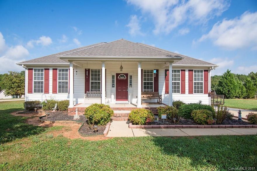 Charming front porch, open floor plan with vaulted ceiling in great room, gas log fireplace, new flooring, fresh paint, corner lot with large deck and yard, storage shed/outbuilding.