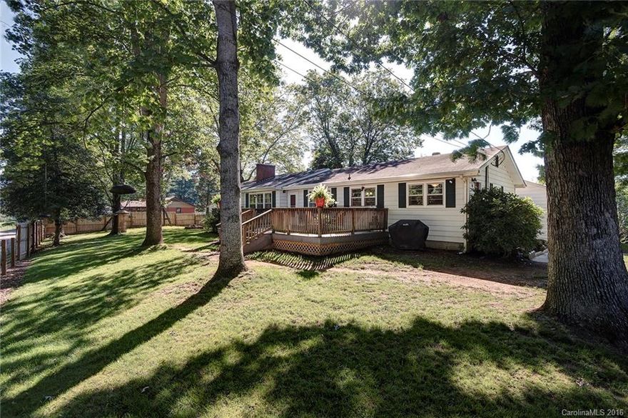 Perfect for families, gardeners & pet lovers.  Great fenced yard with separate sections for kids & pets.  Raised bed gardens with mature herbs, grape vines, rhubarb, & berry bushes.  Upscale chicken coop.  Kid Playhouse. Antique "Summer Kitchen”.  Cool firepit.  Large front deck. Great storage. Open floor plan for the LR, DR & kitchen.  Stainless steel appliances.  Bonus mudroom/office with built in bookshelves.  Heat pump with back up oil & wood stove heat.  Oak floors. 15' to DT Asheville.