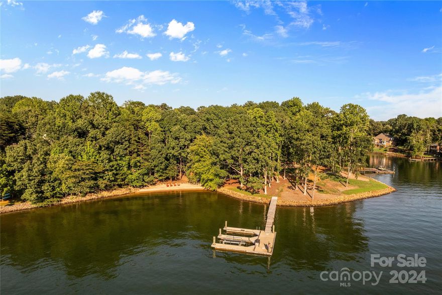 This Double Waterfront Lot Boasting 500’ of Shoreline w/westward facing sunset views is a Stunner! River Rock Shoreline & Magnificent Natural Sandy Beach for all your lake activities. (Not one grain of sand has ever been added!) Enjoy Big Water without movement on the 54,000 lb. concrete floating dock, built by Bellingham Marine in Florida and installed by Lancaster Docks using 15” pilings. Pier has Ipe (Brazilian Walnut) walk, dual slips, & is 17’ deep with lift to convey. Family compound w/ dual residence option or combine to build your Lake Norman Estate!
One of the last remaining lots on Lake Norman that will accommodate 2 docks on one property- giving you boat docking, beach access, and over water entertainment! Lake Norman State Park is your tranquil northern view, within 9 minutes to access miles of hiking & 1300 acres of undisturbed land! Possibilities are Endless w/ this parcel!