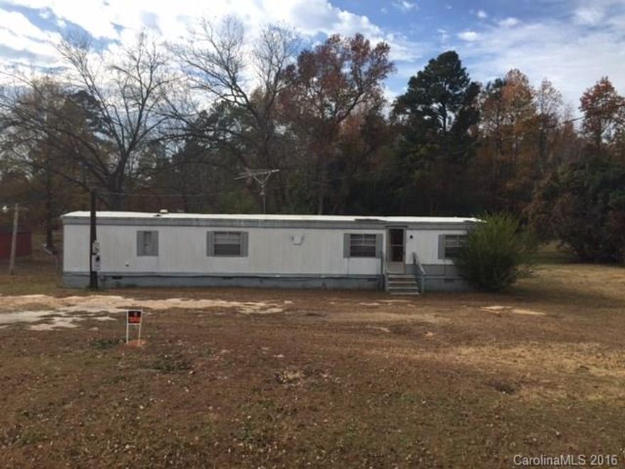 Great investment - Value is in the land - almost an acre at .86 city lot with electrical, sewer and water.  Trailer was previously rented at $350 per month. It is in need of repair owner selling as is where is.  Heating, air and appliances all working.  City passed ordinances against mobile homes so when this one is removed a new one can not be placed there.  Great lot to build or make repairs and continue to rent this trailer out.