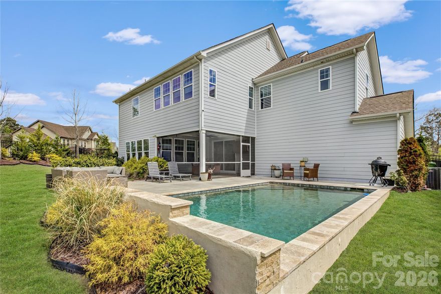 Nestled within the gated Montage section of the amenity-rich Palisades community, this stunning home welcomes you with a charming rocking chair front porch and a thoughtfully designed layout perfect for modern living. Just off the foyer, a convenient main-floor guest suite offers comfort and privacy for visitors. The heart of the home is the gourmet kitchen, featuring a gas cooktop with stainless steel hood, wall oven, an oversized granite prep island with a single-bay sink, white subway-tile backsplash, and abundant cabinetry. Entertain with ease in the dining room, complete with a butler’s pantry/coffee bar and sliding glass doors that open to a screened porch overlooking a sparkling pool, patio, and expansive backyard—your own private outdoor oasis. Saltwater pool installed June 2022- Jandy equipment with natural gas pool heater for year round enjoyment.  The light-filled living room is anchored by a striking stacked stone fireplace, while upstairs, a versatile loft provides the perfect space for relaxing or entertaining. A private study offers flexibility for a home office or playroom. The spacious primary suite is a true retreat with dual vanities, a soaking tub, and a tiled glass-enclosed shower. Bedrooms three and four share a Jack-and-Jill bath, while a fifth bedroom enjoys access to a hall bath, making this home as functional as it is beautiful. LED in-duct air purification system installed March 2024 and Culligan under sink reverse osmosis water purification system with extra faucet. Residents of Palisades enjoy exceptional community amenities, including a clubhouse, resort-style pool, pickleball and basketball courts, a fully equipped fitness center, and miles of scenic walking trails.