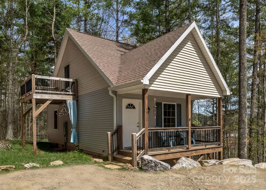 Like-new 2BR/2BA home tucked away in the peaceful, sought-after town of Mars Hill—just a quick stroll to downtown, less than a 1/2 mile away. Surrounded by trees for privacy, this beautiful home offers year-round mountain views & a serene setting. A covered front porch welcomes you inside to a bright, open floor plan with modern finishes & stainless steel appliances in the kitchen. The living room is filled with natural light, with windows framed by scenic views. The main-level bedroom features a private deck with a hot tub—perfect for unwinding under the stars. Upstairs, a private suite lets out onto its very own balcony. Situated on a .90-acre lot, you’ll enjoy space, tranquility, & nature. Mars Hill is known for its University, vibrant arts scene, local shops, charming eateries, & small-town feel—all just 20 minutes from Asheville. Whether you're looking for a mountain retreat, full-time residence, or investment property, this home offers the perfect blend of comfort & convenience.