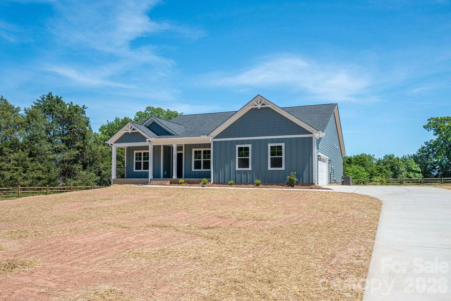 This BRAND NEW single story construction offers 4BR, 2BA, epoxied 2 car side load garage, spacious rooms, a blue/white craftsman style exterior, an open floorplan and a covered back deck and more! This spacious home is sitatuion on an approx .79 acre lot and has a nice tree lined barrier on one side.  The floorplan is open and airy and beams with natural light. The primary suite features a tiled shower and walk in closet. Located right outside of the town of Maiden, this home has super easy access to HWY 321 for an easy commute. The covered back deck or the front covered rocking patio is a great place to unwind after a long day. Come experience single story brand new construction living.
