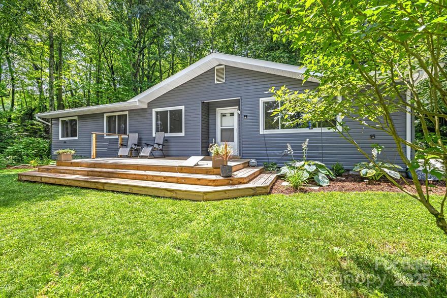 Welcome to 487 Duncan Creek Road—a fully updated 3 BR/2 BA home nestled in a peaceful, wooded Fletcher setting. Inside, enjoy an open-concept layout with new flooring, recessed lighting, and a built-in entry bench. The spacious, redesigned, eat-in kitchen features new cabinets, countertops, and appliances. The owner’s suite offers added windows, crown molding, an oversized custom walk-in closet, and a beautifully renovated bath. The guest bath has also been beautifully updated with modern finishes. Throughout the home, you’ll find fresh paint, new trim, updated doors, and ceiling fans in every room. Outdoor highlights include a new front porch, painted exterior, fire pit patio, concrete parking pad, and refreshed landscaping. Major upgrades include new HVAC with smart thermostat, French drains, and exterior security lighting. Move-in ready with thoughtful details inside and out.