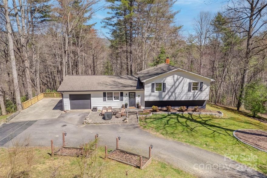 Located in the Little River Valley, just down the road from Dupont State Forest, this 3 bedroom 2 bath home
with large bonus room is perfect for those looking to be surrounded by nature. This low maintenance home
and yard features lovely partial mountain winter views, a lush woodland forest in the warmer months, and ample outdoor areas for enjoying the natural surroundings. Inside you will find vaulted ceilings in the living and dining rooms, and a spacious kitchen overlooking the backyard. On the upper level are two guest bedrooms, a full bath and a primary bedroom with walk in closet and ensuite. The lower level has a large bonus room perfect for entertaining. The back deck and treehouse are great spots for watching sunrise and sunset over the mountains. There is a one car garage on the main level perfect for extra storage. Don't miss out on this move-in ready home nestled right in the heart of the Blue Ridge Mountains.