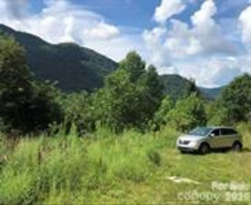 Part of an old farm. Off Hwy 209 , Betsy’s Gap road , clyde ; Hard to find 28.11 acres with improvements and has beautiful Mountain Views, partial fencing,( 4 acres of pasture w/ shed )  2 springs , and is UNRESTRICTED. Located off NC Hwy 209 Betsys Gap Rd, Clyde. Checkout the Long range views, private corner lot, older MF home stays ( personal property, Being sold AS IS ) needs repairs , OR build your dream home here! 
Has gravity flow Spring water,(Needs hooked back up)  lower part of the Land is rolling/ somewhat sloping, some hilly,  Mountain is steep but has old winding trails. Septic in place, electric in place, road to homesite in place, Also has additional approved septic perk certificate located below the present home site  ( lower area of land ) Lots of possibilities! 
No personal property or junk ( if any ) will be removed from the property by the seller. The sellers are
Heirs and have not lived on the property. Being sold AS IS. 
An addendum to any offer to purchase contract will have to be added stating that the seller will not be removing any personal property ( old
MF home ) or junk ( if any ) off of the property. 
 Disclosure: Listing agent is related to some of the sellers. 

Come own Your very own mountain today!